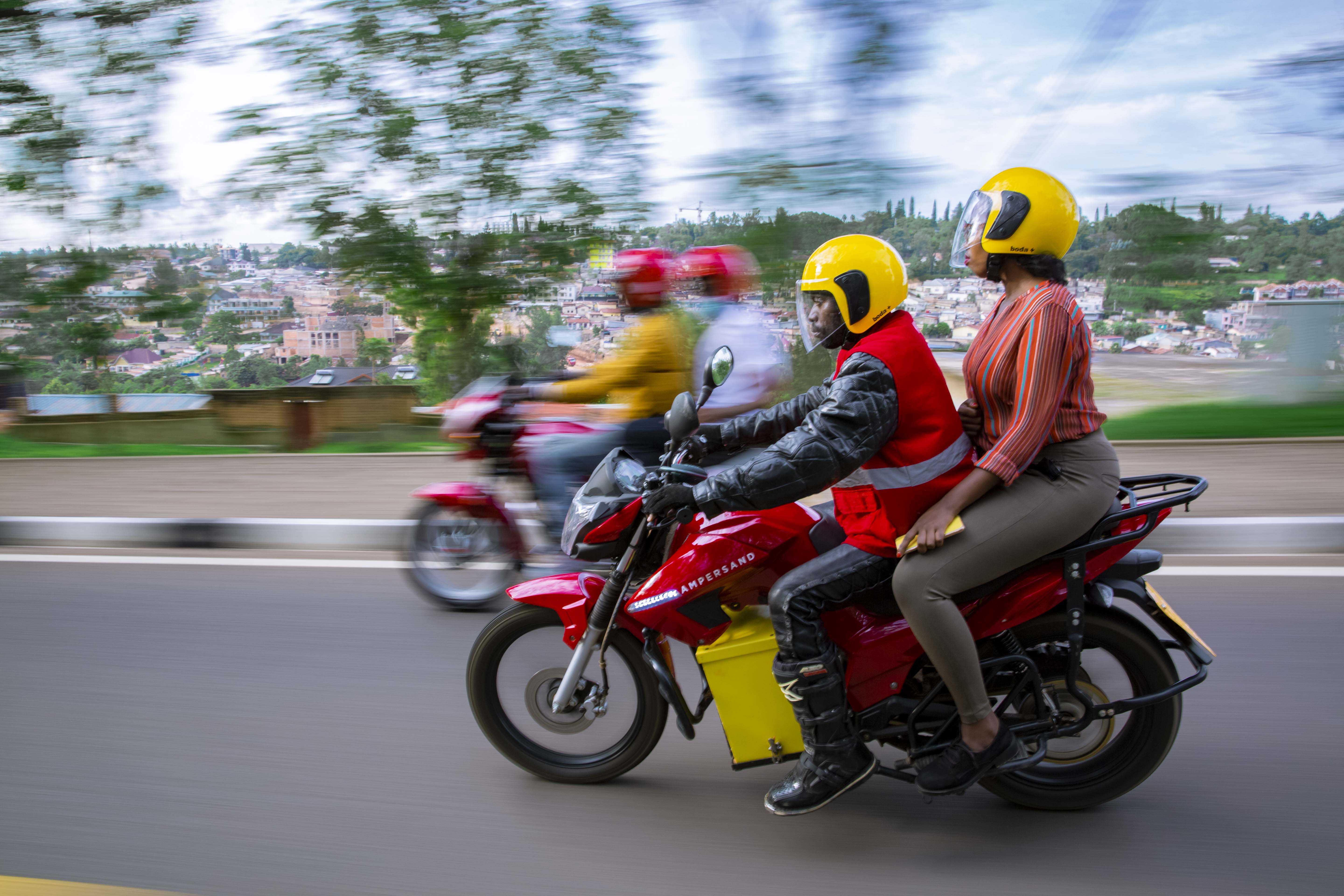 An electric motorcycle in Nairobi carrying a woman passenger.